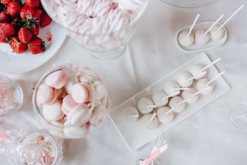 Close-up Photo of Elegant Sweet Table of Pink Macaroons, Zefir and Tasty Strawberry. Wedding Delicious Dessert White Romantic Background. Beauty Food Decoration for Happy Love Ceremony