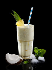 cocktail with pineapple and coconut on a black background