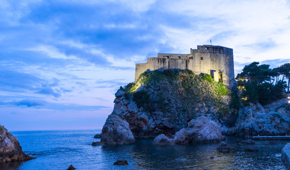 Fototapeta na wymiar The historic wall of Dubrovnik Old Town, Croatia. Prominent travel destination of Croatia. Dubrovnik old town UNESCO World Heritage. Castle at night in the sea