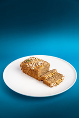 Almond bread loaf with Almond diced and Banana sliced set on Blue Background.