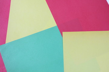 colored paper of different shades, geometrically laid out on the surface
