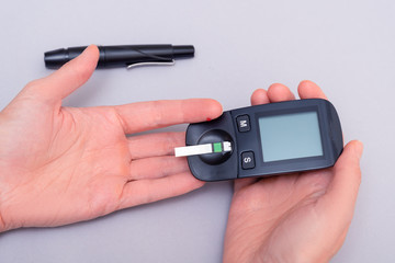 Woman use blood glucose detector