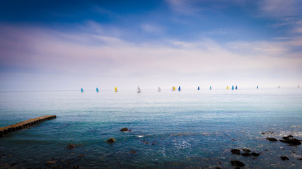 line of tiny sails on the horizon
