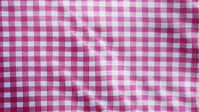 Pink white tablecloth, picnic gingham is waving. Top view checkered fabric cloth background.