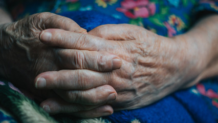 old hands and arms. wrinkled skin of aged person. aging process. risk group coronavirus or covid virus