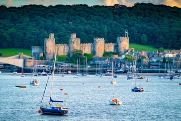 Boats in the estuary Conwy River and Conway Castle