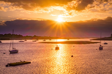 Sunset over Conwy Estuary with small boats