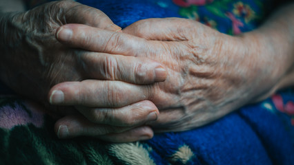 Fototapeta premium Elderly woman hand palm. Old lady arms, freckles. wrinkled skin of aged person. aging process. risk group coronavirus or covid virus