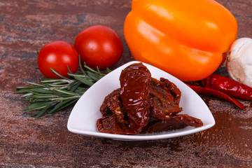 Dried tomatoes in the bowl with olive oil