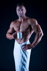 Sport and fitness. Body hygiene concept. Bodybuilder perfect naked body. Sexy sportsman wipe body...