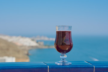 Wineglass with the red wine against relaxing view.