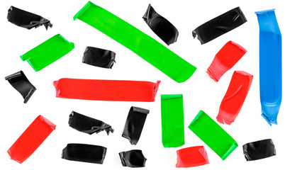 Set of colored tape slices isolated on white background. Insulating tape of different shapes and colors.