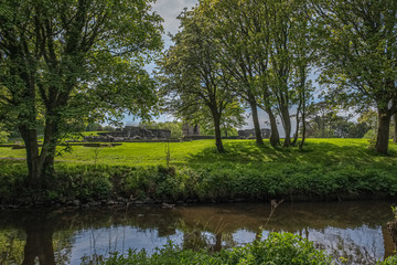 Scotlands Parks Ancient Ruins Lucious Greenery and a Gentle Flowing River with Reflections on the Water.
