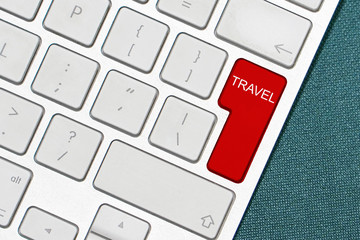 Keyboard with word Travel. Computer notebook keyboard with Travel key. Travel concept with key on keyboard from computer. Red Travel button on the keyboard close-up.Computer keyboard with word Travel.