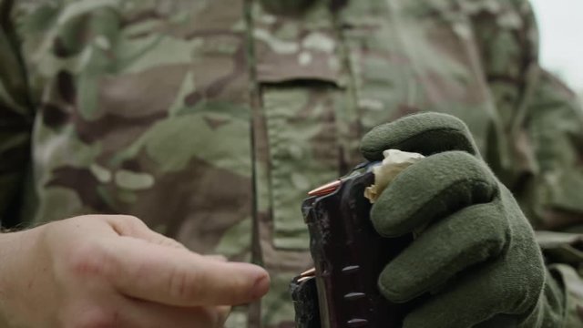 Kalashnikov rifle charging. Unlocking assault rifle. AK 47 loading. Soldier hand charging rifle magazine.