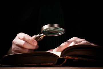 Lawer holding magnifying glass. Criminal case investigation