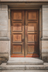 Fototapeta na wymiar Old wooden door isolated on historic building -