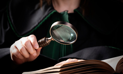 Lawer holding magnifying glass. Criminal case investigation