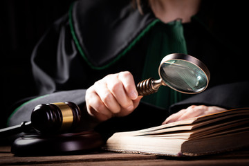 Lawer holding magnifying glass. Criminal case investigation