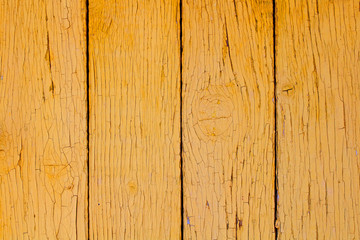 Old painted wooden yellow boards. Vertical view. Close-up. Background. Texture.