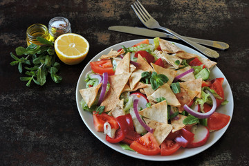 Bright healthy salad with vegetables and pita bread. Fattush Salad.