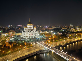 Fototapeta na wymiar Cathedral of Christ the Savior in Moscow near river, Russia at night. Aerial drone view