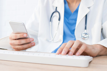 doctor's hands with mobile phone