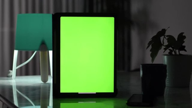 Dolly shot of Tablet computer with green screen chroma key.