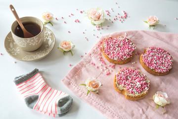Obraz na płótnie Canvas cup of tea with crispy rusk with traditional Dutch food pink muisjes, aniseed, for celebration birth of a daughter