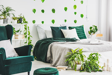 White bedroom interior with king size bed with grey nd emerald bedding, urban jungle and green leaf...