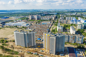 Fototapeta premium Aerial view of construction site of new modern apartment residential building, drone photo