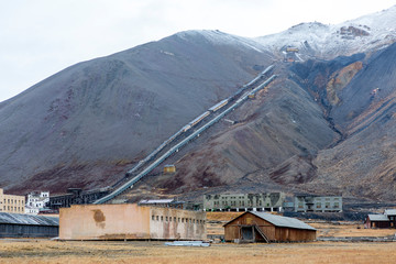 The sudden abandoned russian mining town Pyramiden, snowcaped mountain in the back, Isfjorden,...