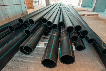 Group of new plastic pipes or tubes on construction site
