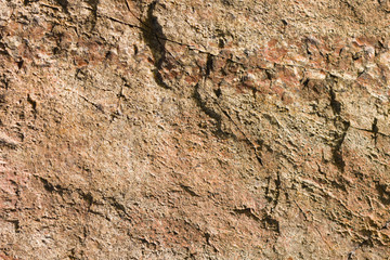 Background of granite. Texture of granite stone. Pattern of roughened surface. Texture of brown stone