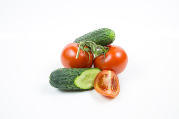 Fresh red tomatoes and cucumbers isolated on white background Food and drink Agriculture