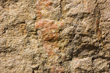 Background of granite. Texture of granite stone. Pattern of roughened surface. Texture of brown stone