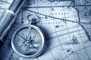 compass and spyglass on medieval map - obrazy, fototapety, plakaty