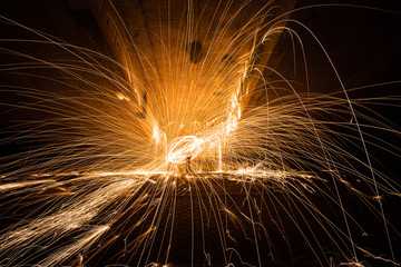 Burning Steel Wool spinning. Showers of glowing sparks from spinning steel wool