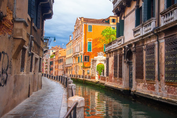 Fototapeta na wymiar Venice street along canal, Italy. Venezia cityscape. Beautiful Venice