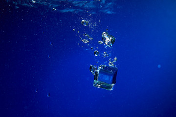 Ice cubes falling into the water