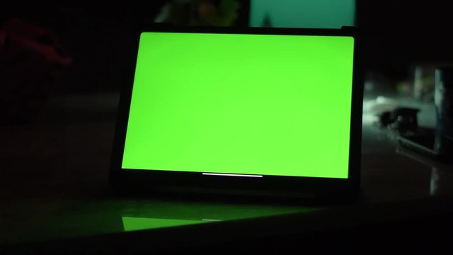Dolly shot of Tablet computer with green screen chroma key.