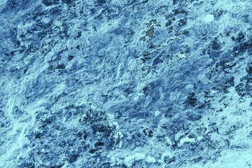 Vintage blue background. Rough painted wall of sapphire color. Imperfect plane of blue colored. Uneven old decorative toned backdrop of cyan tint. Texture of sapphirine hue. Ornamental stony surface.