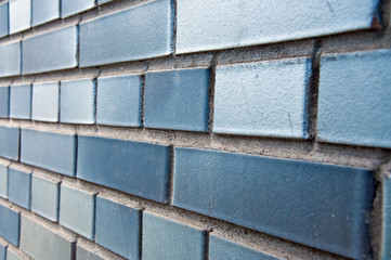 The wall is made of bricks. Brickwork in the construction of a new building. The use of a classic building material.