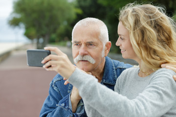 senior man and young lady talking self portrait photograph