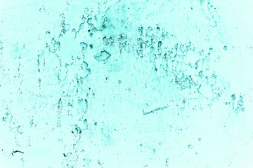 Vintage azure background. Rough painted wall of turquoise color. Imperfect plane of cyan colored. Uneven old decorative toned backdrop of aqzure tint. Texture of teal hue. Ornamental stony surface.