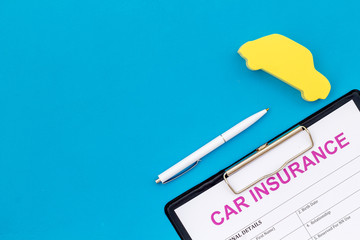 Car insurance concept with form, car toy on blue background top view mockup