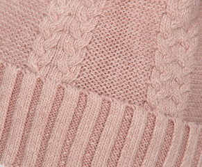 Fototapeta na wymiar background of knitted wool threads, knitting on the cap, headdress close-up