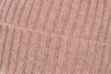 background of knitted wool threads, knitting on the cap, headdress close-up