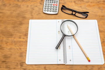 Top view of wooden desktop with office tools. Mock up, soft focus.