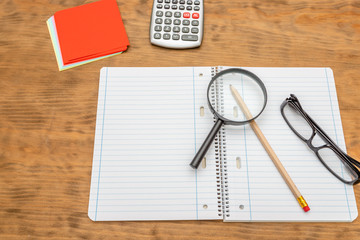 Top view of wooden desktop with office tools. Mock up, soft focus.